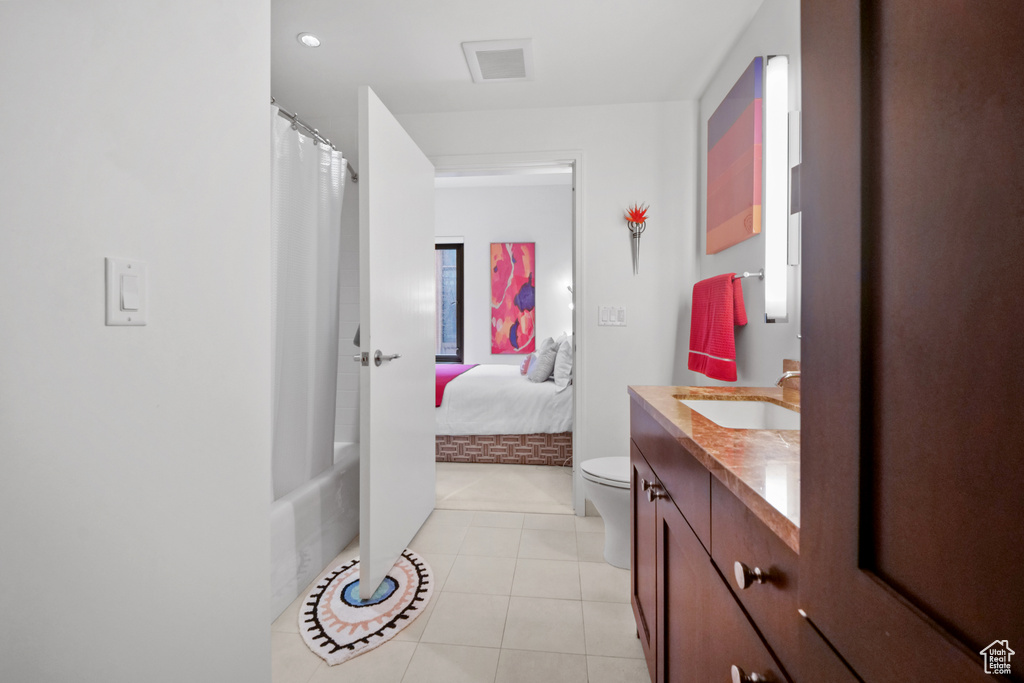 Bathroom featuring vanity, tile patterned flooring, and shower / bathtub combination with curtain