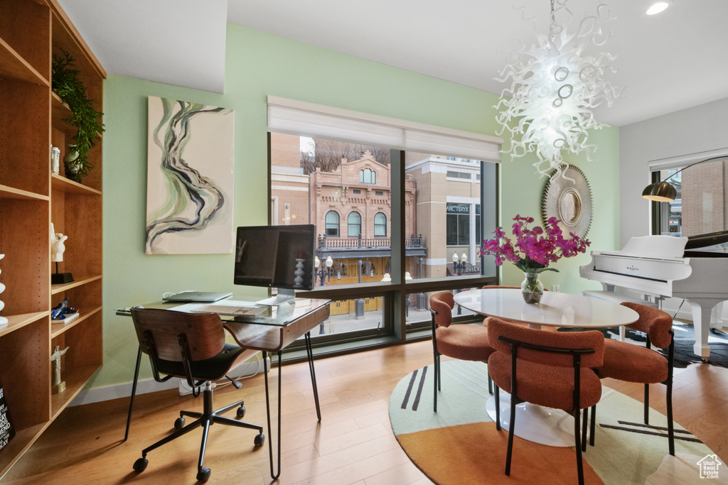 Dining room with healthy amount of natural light, wood finished floors, a desk, and recessed lighting