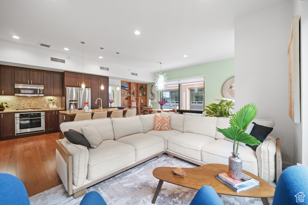 Living area featuring hardwood / wood-style floors and recessed lighting