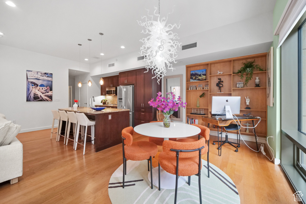 Dining area with light wood-type flooring, recessed lighting, and an office area