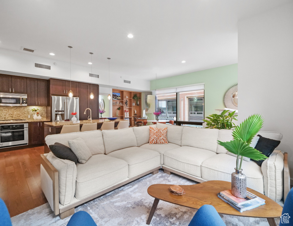 Living area with wood finished floors and recessed lighting