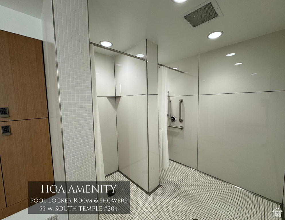 Bathroom featuring walk in shower, tile patterned floors, and recessed lighting