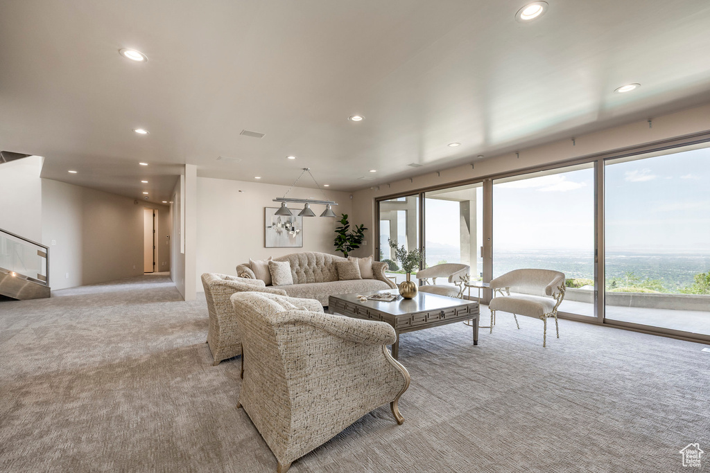 Living area featuring light colored carpet and recessed lighting