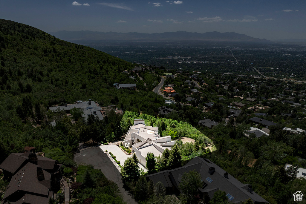 View of property location featuring mountains and a heavily wooded area