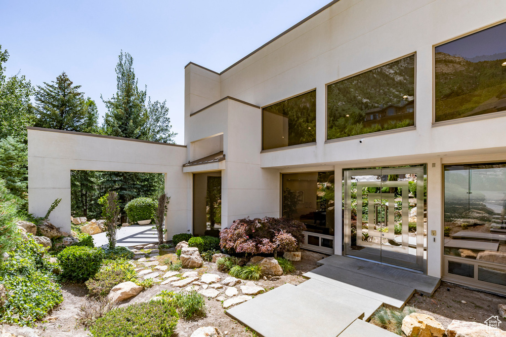 Doorway to property featuring stucco siding