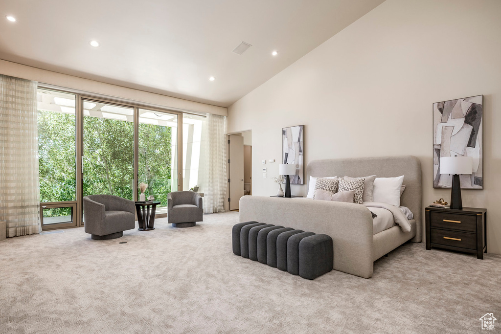 Carpeted bedroom with recessed lighting, high vaulted ceiling, and access to exterior