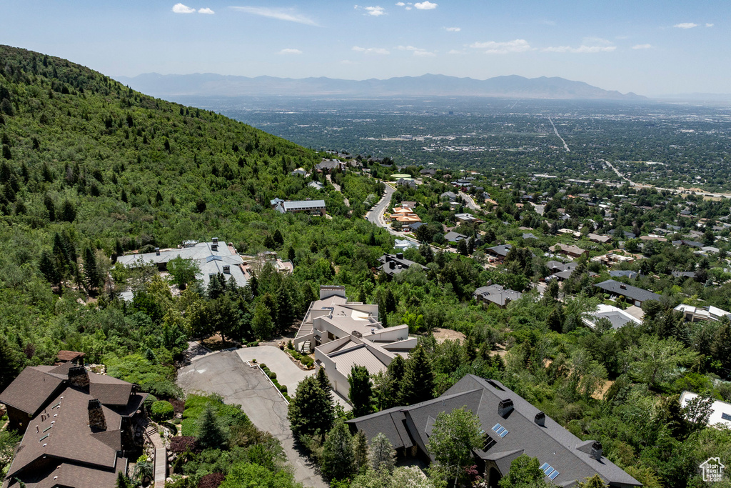 Aerial view of property's location featuring mountains and nearby suburban area