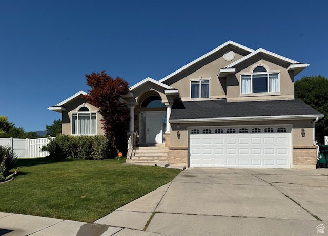 Craftsman-style home with stucco siding, a garage, and concrete driveway