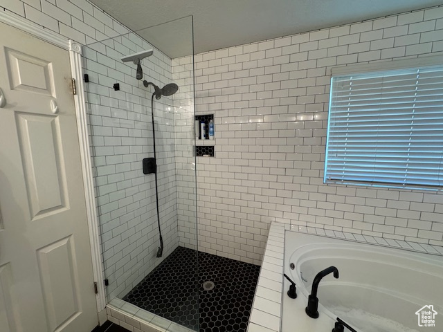 Bathroom with a stall shower and a garden tub