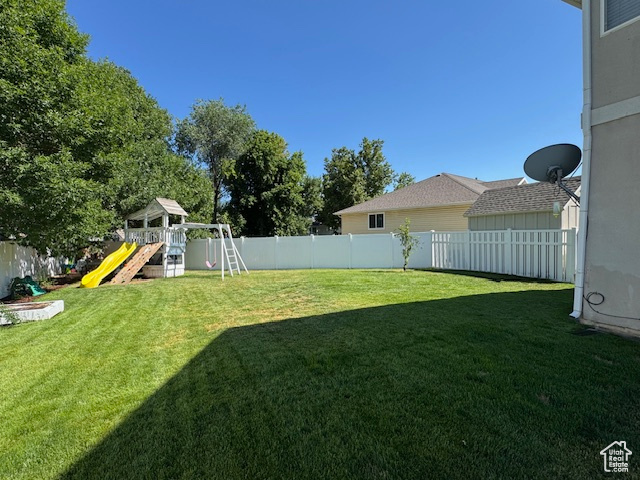Fenced backyard with a playground