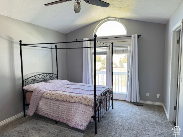 Carpeted bedroom featuring lofted ceiling, access to outside, a textured ceiling, and ceiling fan