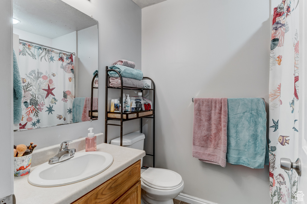 Full bath featuring vanity and curtained shower