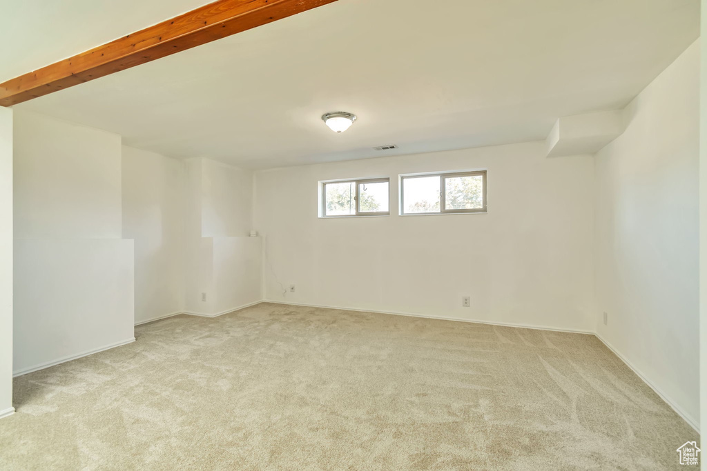 Empty room featuring light colored carpet