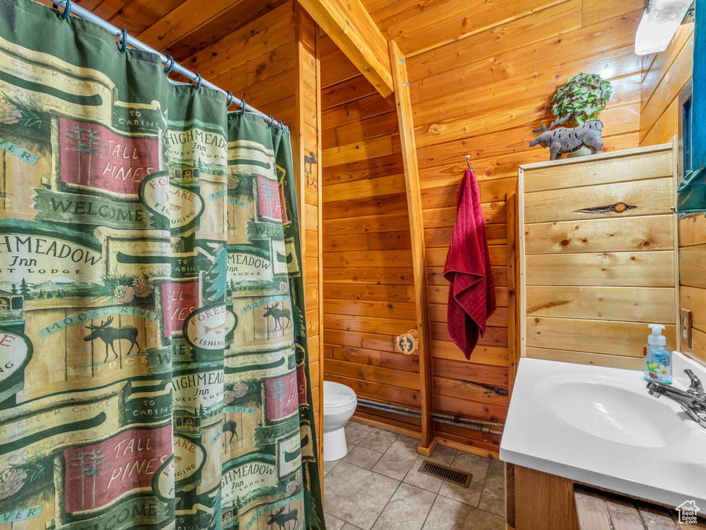 Full bathroom with wooden walls, vanity, tile patterned flooring, curtained shower, and wooden ceiling