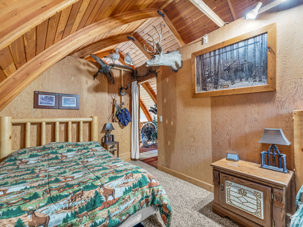 Bedroom featuring wood ceiling, carpet floors, vaulted ceiling, and wood walls