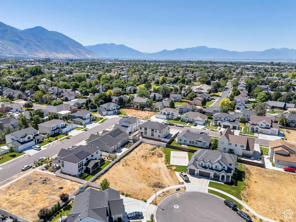 Aerial view of residential area featuring a mountainous background