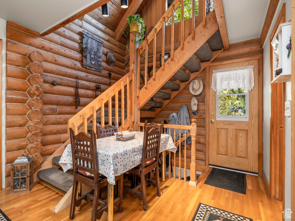 Dining area with rustic walls and wood finished floors