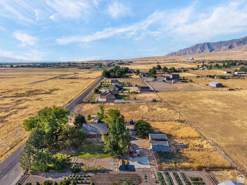 Aerial view of property and surrounding area featuring rural landscape and mountains