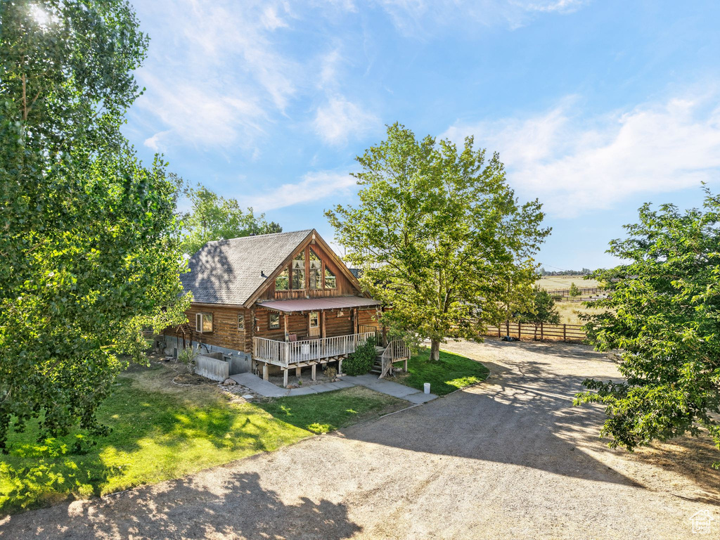 Log cabin with a porch and a shingled roof