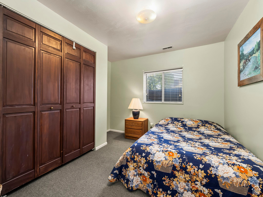 Bedroom with carpet and a closet