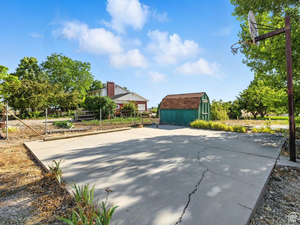 View of basketball court featuring a shed