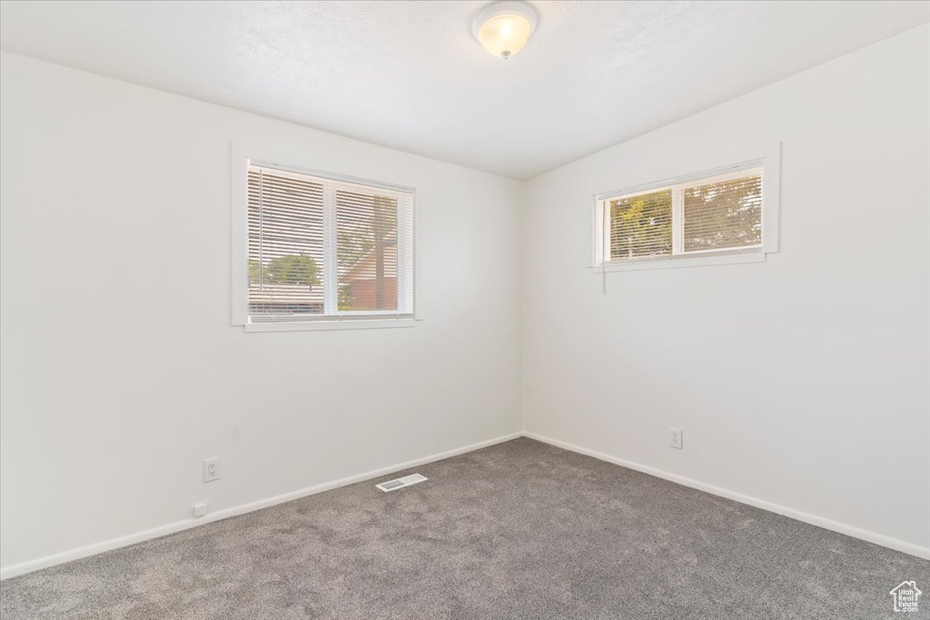 Empty room with carpet flooring and baseboards