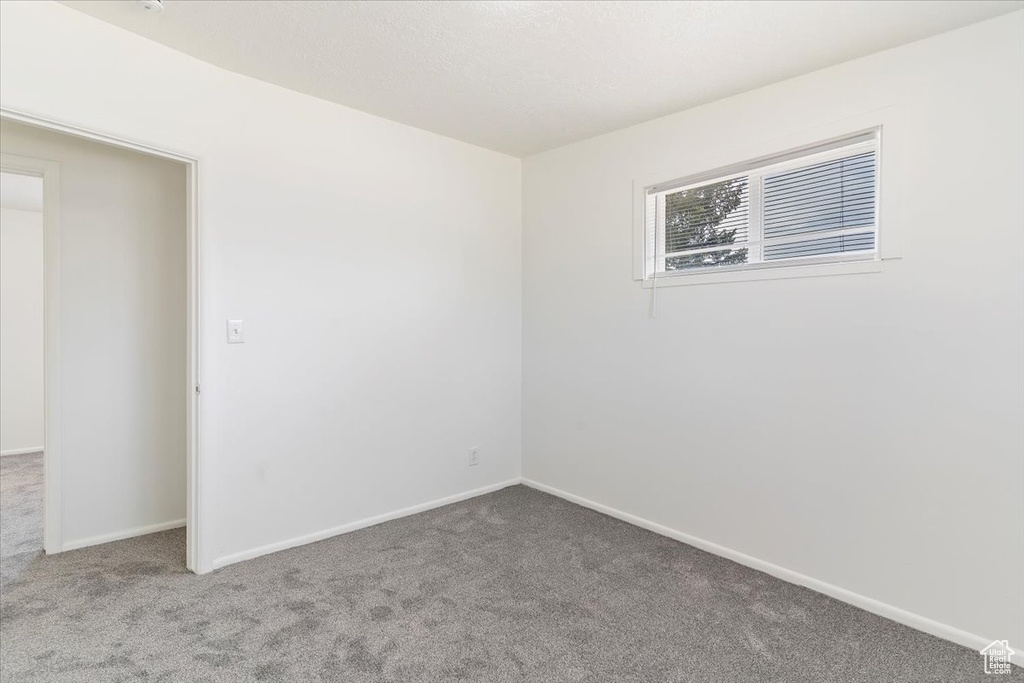 Carpeted spare room with baseboards