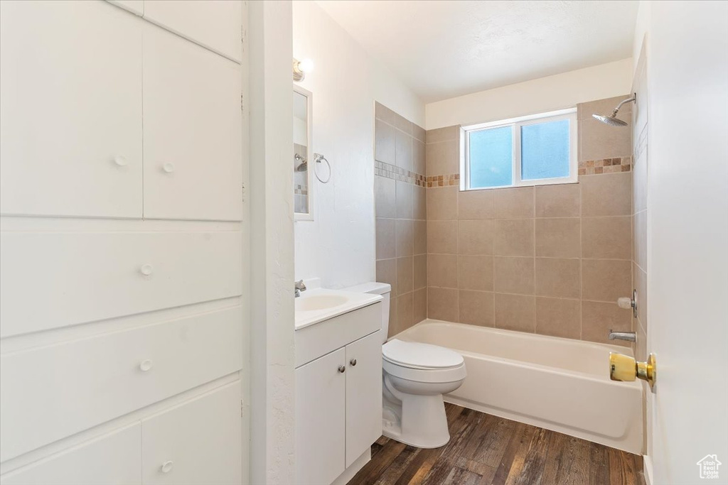 Bathroom with vanity, shower / washtub combination, and wood finished floors