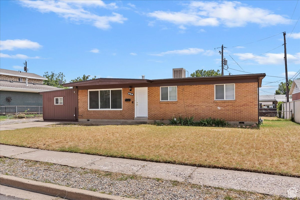 View of front of property with crawl space, brick siding, and driveway