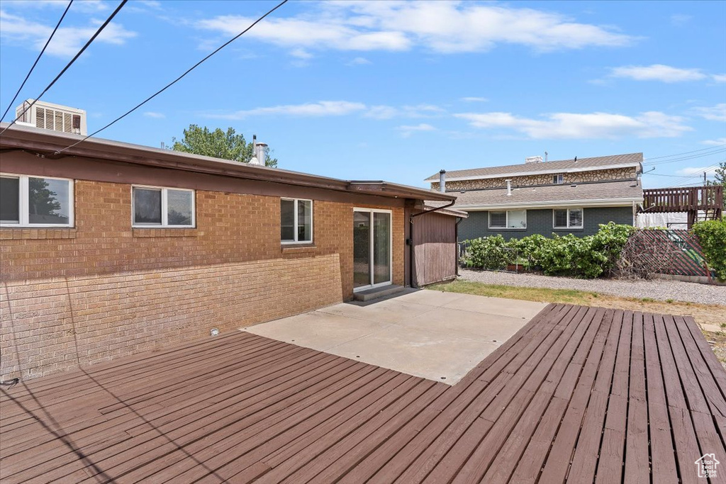 Wooden terrace featuring a patio area
