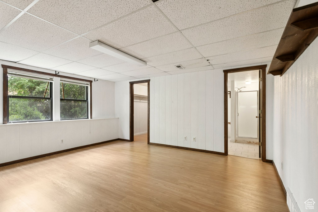 Spare room with a paneled ceiling and wood finished floors