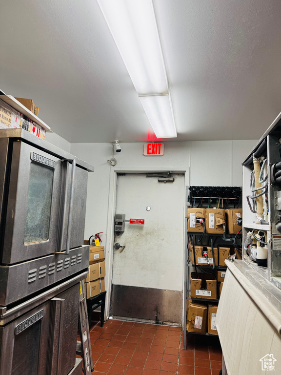 Kitchen featuring high end stainless steel range and tile patterned floors