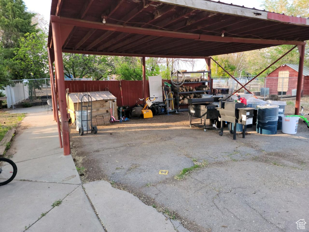 View of parking / parking lot with a carport
