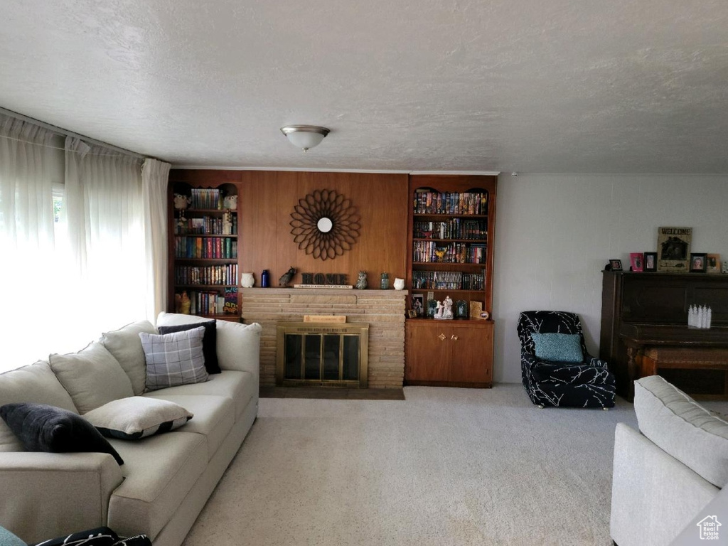 Living area featuring a fireplace and carpet flooring