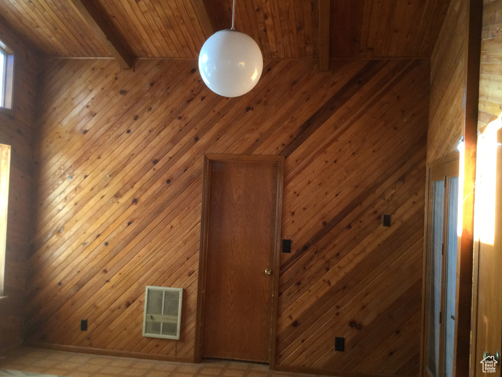 Detailed view of a wooden ceiling with exposed beams, wooden walls, and a relaxing sauna
