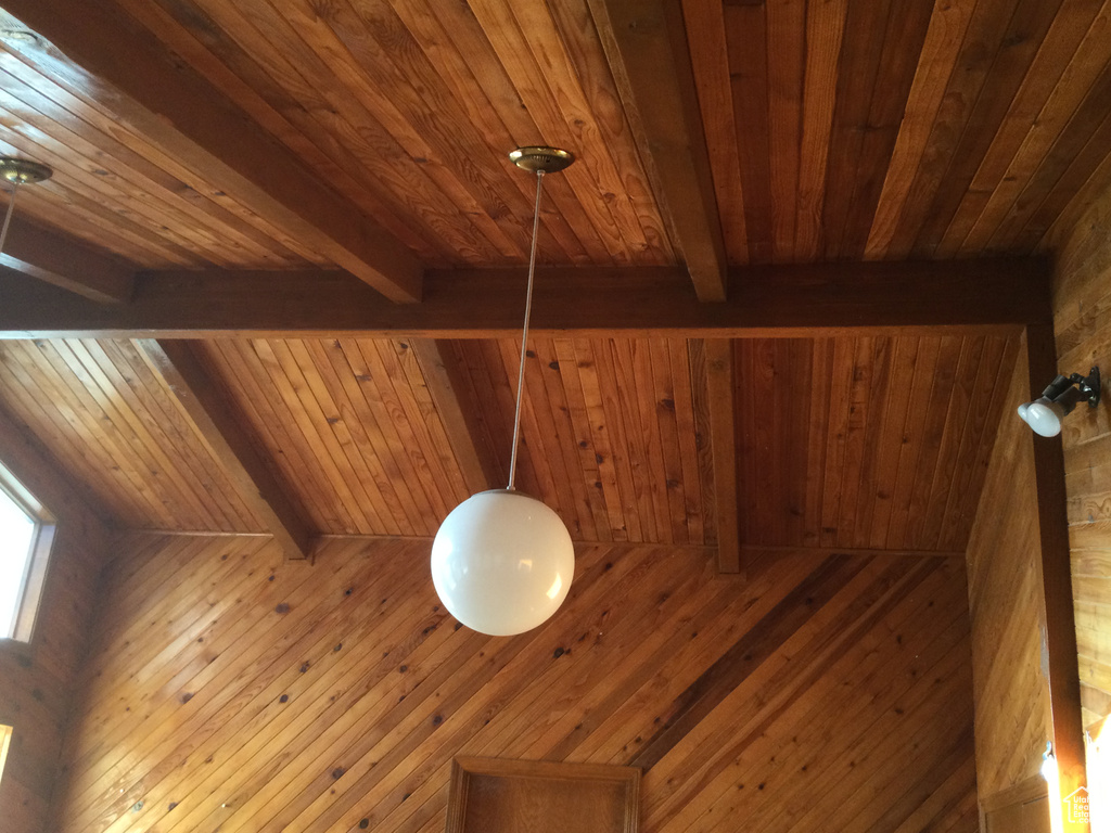 Detailed view of a wooden ceiling with exposed beams, wooden walls, and a relaxing sauna