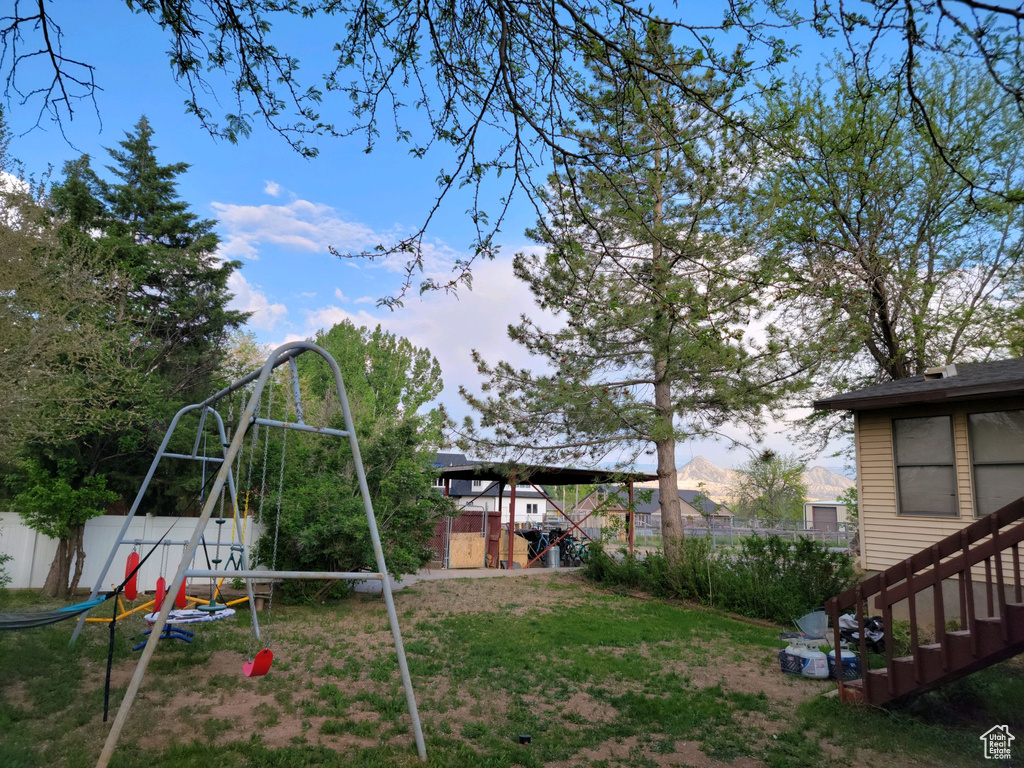 View of yard featuring a playground and a mountain view
