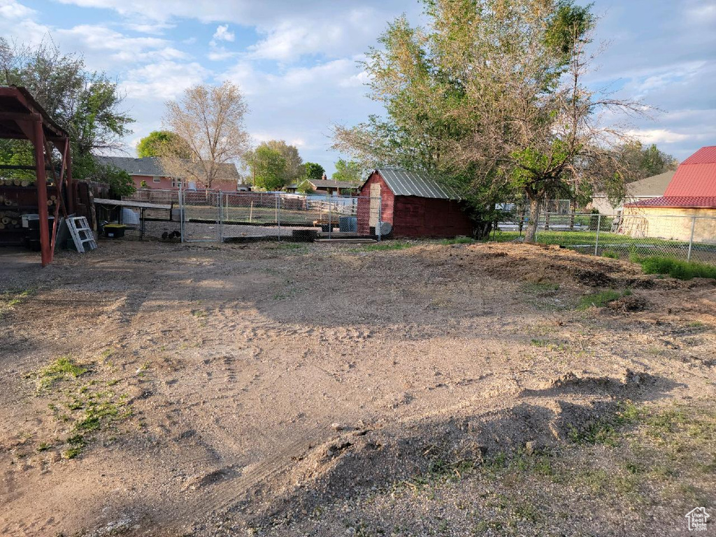 View of yard with a storage unit