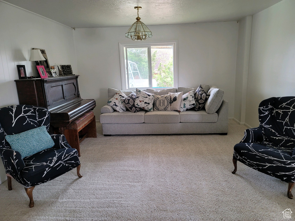 Living area with carpet floors and a chandelier