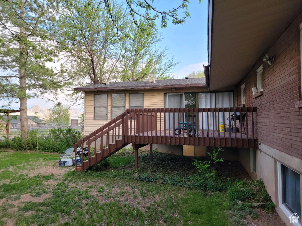 Rear view of property with a wooden deck and stairs