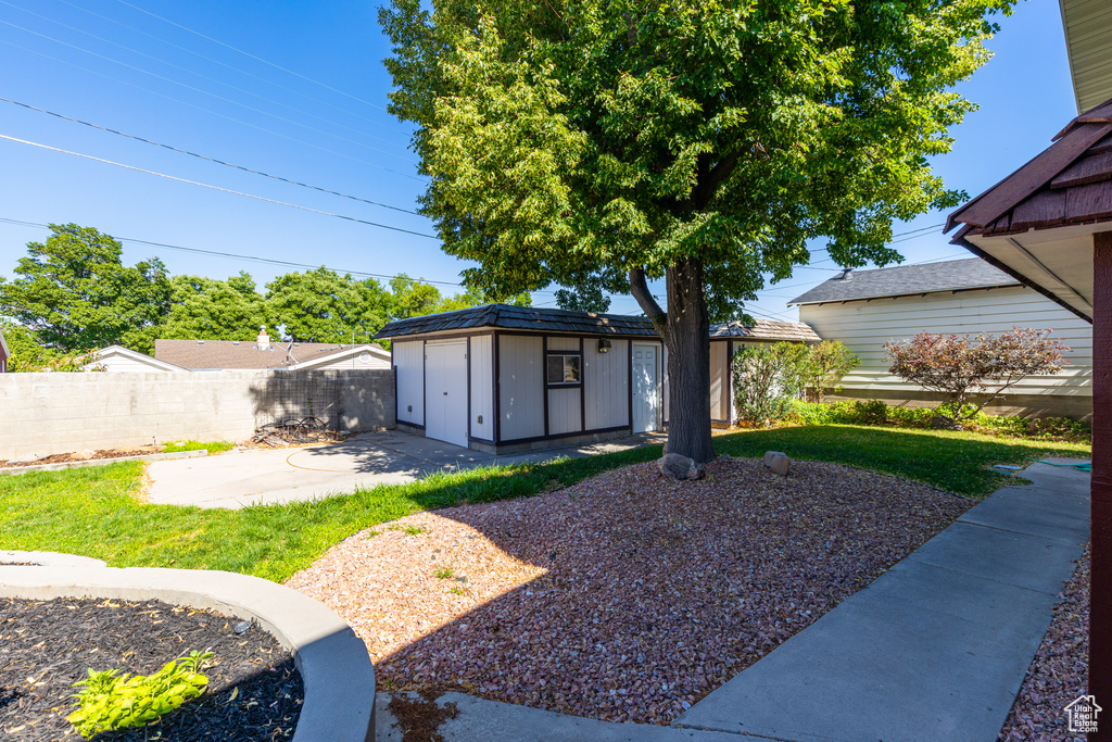 View of yard featuring a storage shed and a patio
