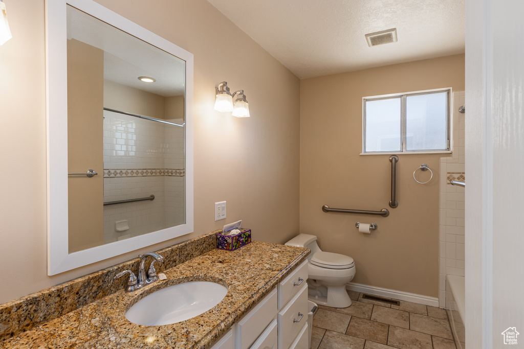 Bathroom featuring vanity and washtub / shower combination