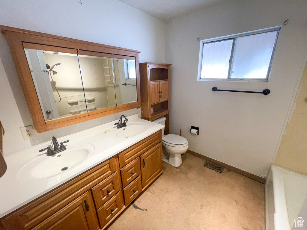 Bathroom with double vanity, a shower, and a bathtub