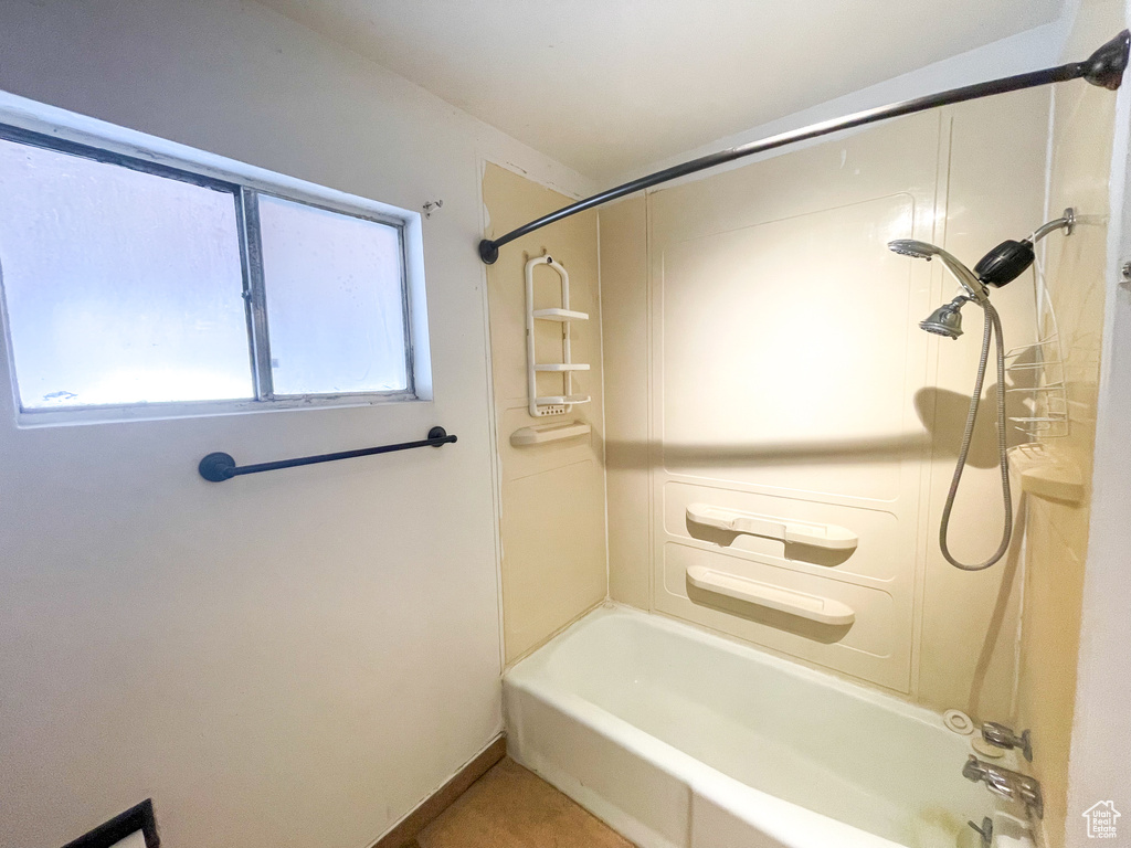 Bathroom featuring washtub / shower combination