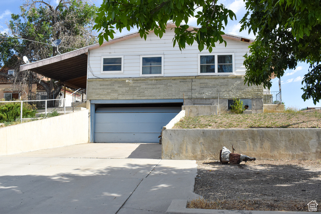 View of front of home featuring a garage and driveway