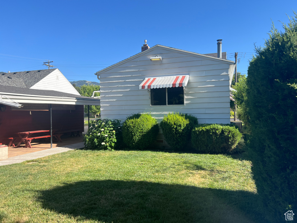 Back of house with a yard