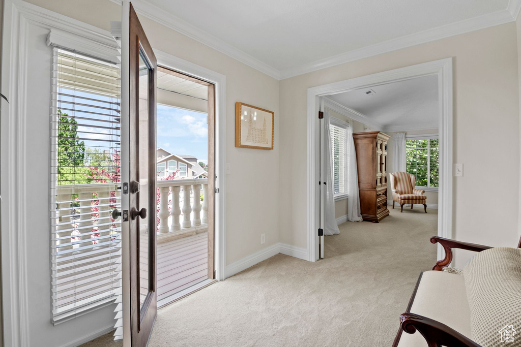 Doorway with carpet, crown molding, and french doors