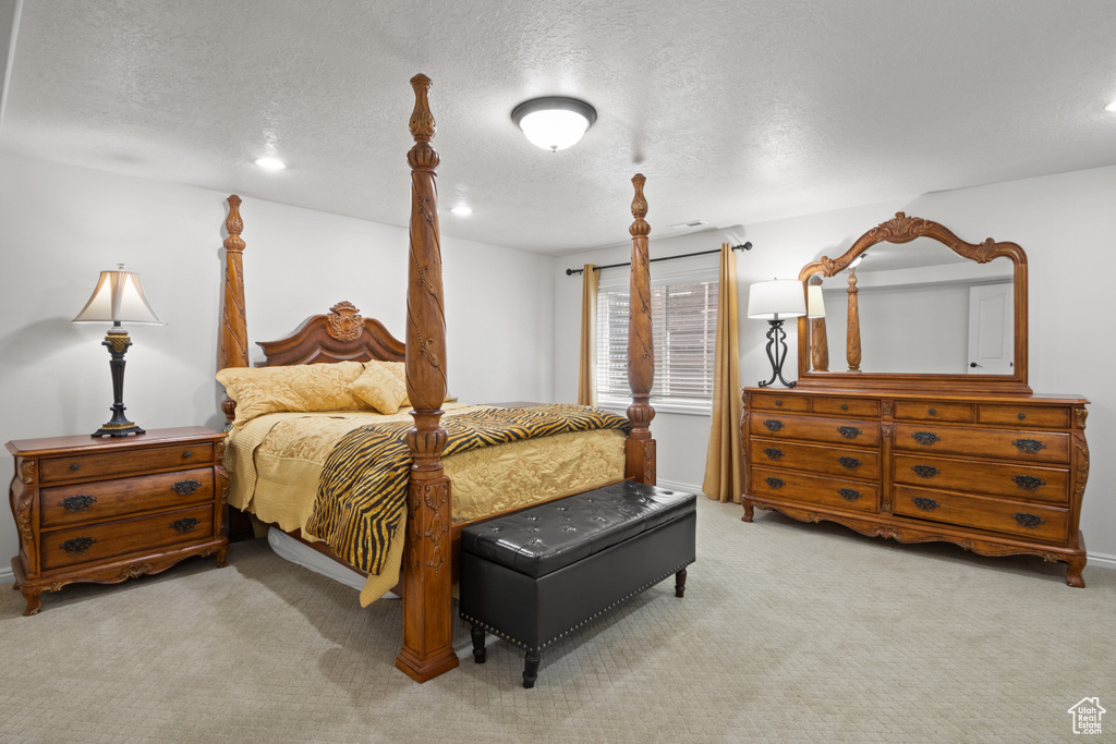 Carpeted bedroom with a textured ceiling