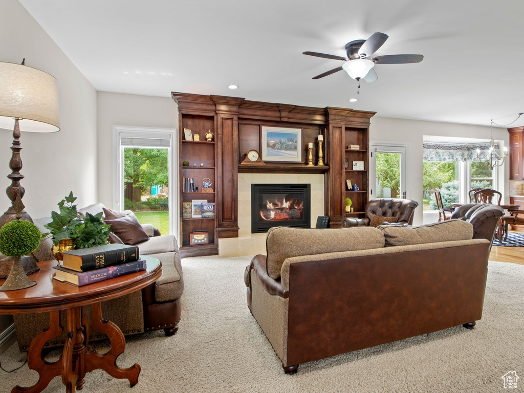 Living area featuring a large fireplace, plenty of natural light, recessed lighting, a ceiling fan, and light carpet