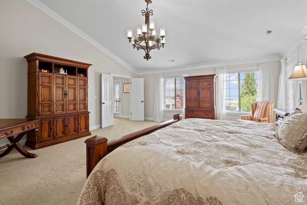 Carpeted bedroom with a chandelier, crown molding, and lofted ceiling